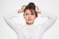 Annoyed tensed young woman pulling her hair by hands