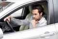 Annoyed tired young man riding driving car. Businessman late for meeting