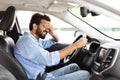 Annoyed tired young middle eastern man is riding driving car Royalty Free Stock Photo