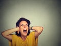 Annoyed unhappy stressed woman covering her ears, looking up, screaming Royalty Free Stock Photo