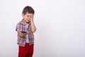 Annoyed upset little kid with smartphone reading fake news.