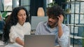 Annoyed woman business mentor teaching male intern help laptop work problem difficulties lazy man shrug shoulders Royalty Free Stock Photo