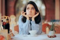 Annoyed Woman Covering Her Ears in Noisy Restaurant Royalty Free Stock Photo