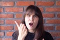 Annoyed woman screaming due to conflict, showing all anger and angerAnnoyed brunette woman with bangs wearing a black t-shirt Royalty Free Stock Photo