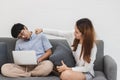 Annoyed young Asian couple fighting in living room after conflict quarrel. Mistrust and cheat problems