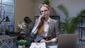 Annoyed young businesswoman talking on retro telephone call irritated voice dissatisfied with work