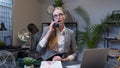 Annoyed young businesswoman talking on retro telephone call irritated voice dissatisfied with work