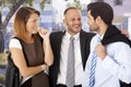 Annoying businessman celebrating with colleagues Royalty Free Stock Photo