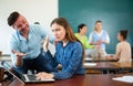 Annoying man student trying to talk with woman Royalty Free Stock Photo