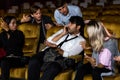 Annoying man talking on phone at movie theater Royalty Free Stock Photo