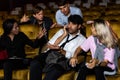 Annoying man talking on phone at movie theater Royalty Free Stock Photo