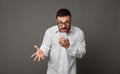 Angry furious businessman in glasses holding cell phone Royalty Free Stock Photo