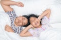 Sister closing ears with hands suffering from loud snore from her brother Royalty Free Stock Photo