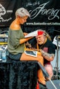 annual convention of professional tattoo artists in Berlin. One professional master tattoo artist makes a tattoo on the a leg of