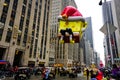 The annual Macy`s Thanksgiving Day parade along Avenue of Americas with many balloons floating in the air