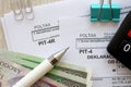 Annual and monthly declarations of income tax advances, PIT-4, PIT-4R form on accountant table with pen and polish zloty