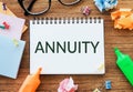 ANNUITY text on a paper notebook, business concept