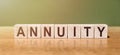 ANNUITY word written on wooden blocks on wooden table. Concept for your design