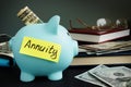 Annuity written on yellow sheet and piggy bank. Royalty Free Stock Photo