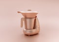 Anodized Rose Gold Material single color kitchen appliance, Pressure Cooker, on light pinkish color background, 3d rendering,