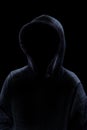 Mysterious Man in Hoodie Silhouette isolated on Black Background Royalty Free Stock Photo