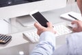 Anonymous business man typing on mobile device on office desk, v Royalty Free Stock Photo