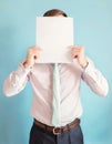 Anonymous businessman covers his head using a blank sheet to hide face expression. Incognito business person hidden behind a white Royalty Free Stock Photo