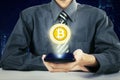 Anonymous businessman showing virtual bitcoin