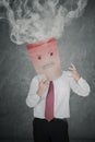 Anonymous businessman with smoke over his head Royalty Free Stock Photo