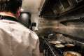 Anonymous chef standing on restaurant kitchen