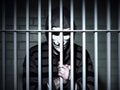 Anonymous hacker behind bars. Arrested in jail. Penalty due to cybercrime