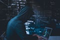 Anonymous hacker with laptop in front of binary code cyber security Royalty Free Stock Photo