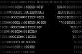 Anonymous hacker without face and binary code background