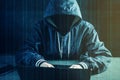 Anonymous hacker programmer uses a laptop to hack the system. Stealing personal data. Concept of cyber crime Royalty Free Stock Photo