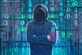 Anonymous hacker standing over binary numbers rain