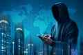 Anonymous hacker using mobile phone Royalty Free Stock Photo