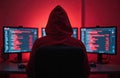 Anonymous hacker wearing red hoodie breaks cybersecurity using computers, dark. Programmer codes malicious software, access Royalty Free Stock Photo