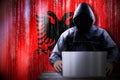 Anonymous hooded hacker, flag of Albania, binary code - cyber attack concept Royalty Free Stock Photo