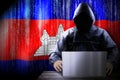 Anonymous hooded hacker, flag of Cambodia, binary code - cyber attack concept Royalty Free Stock Photo
