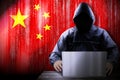 Anonymous hooded hacker, flag of China, binary code - cyber attack concept Royalty Free Stock Photo