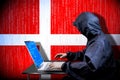Anonymous hooded hacker, flag of Denmark, binary code - cyber attack concept Royalty Free Stock Photo