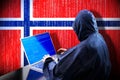 Anonymous hooded hacker, flag of Norway, binary code - cyber attack concept Royalty Free Stock Photo