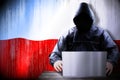 Anonymous hooded hacker, flag of Poland, binary code - cyber attack concept Royalty Free Stock Photo