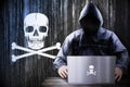 Anonymous hooded hacker, pirate skulls, binary code - cyber attack concept Royalty Free Stock Photo