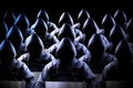 Anonymous hooded hackers, black background, binary code - cyber attack concept