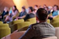 Anonymous male manager sitting in armchair at forum