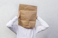An anonymous man with a box on his head, constricting his identity