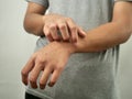 Anonymous man feel itchy, scratching his hand in pain