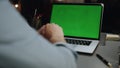 Anonymous man typing chromakey laptop at home closeup. Guy using mockup device