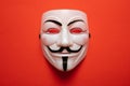 Anonymous mask against red background, closeup view